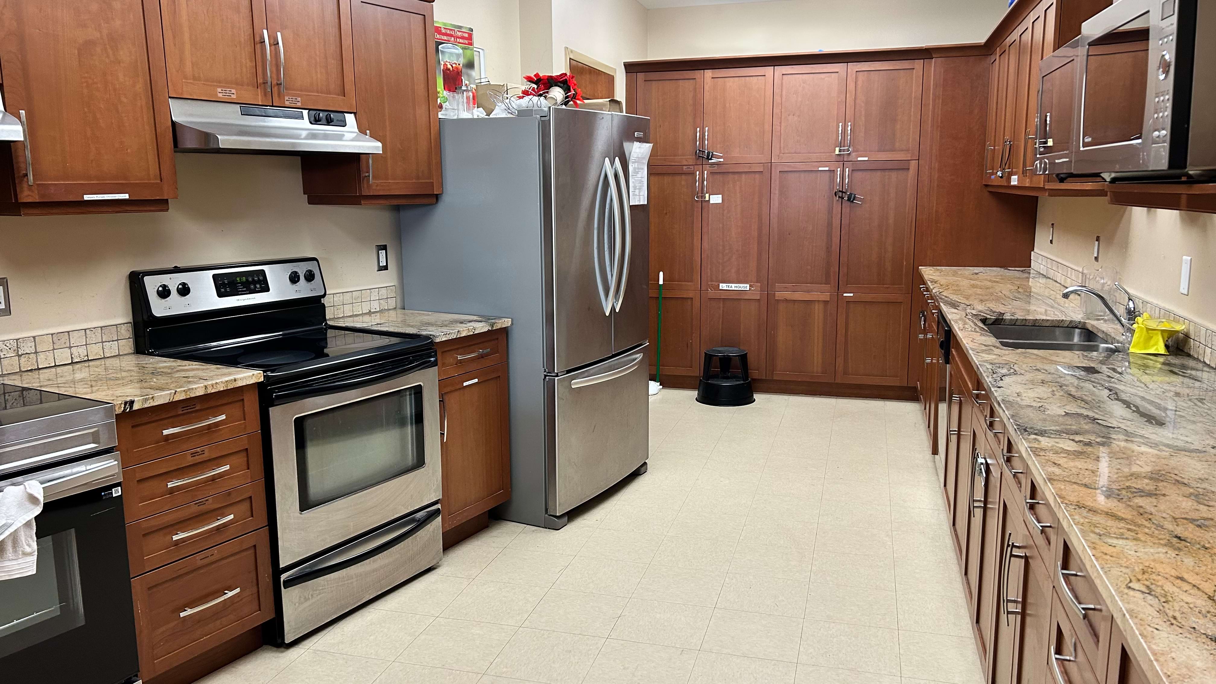 Modern kitchen with stainless steel appliances and wooden cabinets.